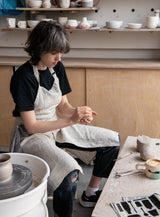 Tablier d'artisanat en lin à jambes séparées Confetti Mill, mise en scène atelier, ambiance créative et naturelle